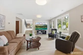 Expansive lower-level living space with patio access, oversized windows, and great flexibility for relaxing or entertaining.