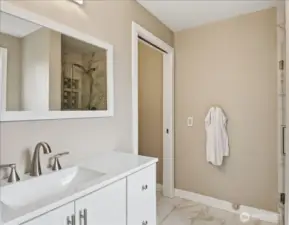 Updated 3/4 bath with modern vanity, tile floors, and clean, refreshed finishes.