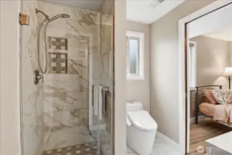 Stylish 3/4 bath with glass-enclosed tile shower and easy access from the adjacent fourth bedroom.