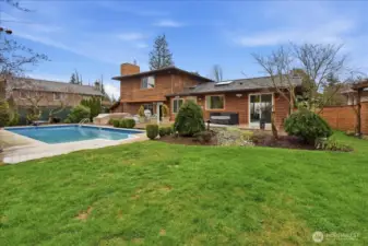 Expansive backyard with in-ground pool, hot tub, composite deck, and plenty of space to relax or entertain.