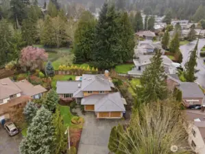 Aerial view showcasing the home’s cul-de-sac setting, backyard retreat, and direct access to the community park behind.