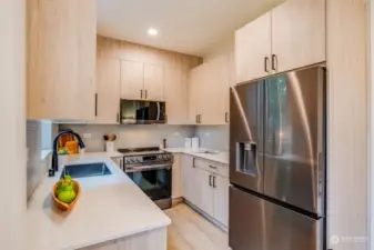 The modern kitchen is fully equipped with Quartz countertops and LG appliances