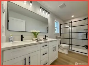 Double vanity and beautiful glass door grace the primary bathroom