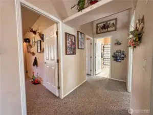 Wide open hallways lead to bedrooms and bathroom