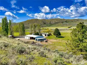 99' Fleetwood with 2,080sf, 2-car attached garage, multiple outbuildings on 7.41 acres
