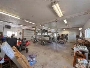 Interior of heated detached garage/shop (boat not included) gives you more enclosed equipment & parking space, plus workshop area