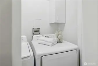 The laundry area near the kitchen with a newer washer and dryer.