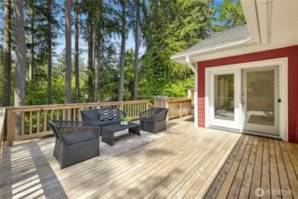 The large deck on the back of the home has great space for lounging and dining, plus a built-in hot tub adjacent to the primary bedroom.