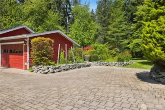 The flat driveway has custom pavers, which makes for an easy approach. There is ample parking including space for an RV.