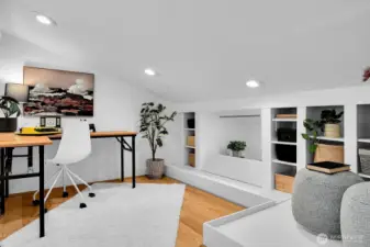 The loft area, with a sloped ceiling. This space is not included in unit square footage
