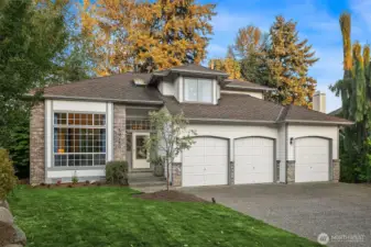 Beautiful setting for this updated 90's home with a 3 car garage and large flat driveway. Newer roof and gutters updated landscaping and exterior lighting. West facing for tons of natural light! Central air to keep it all cool in the summer!