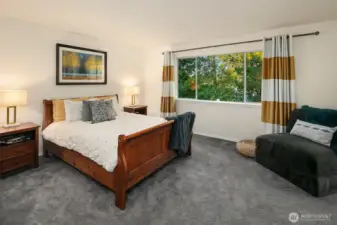 At the top of the stairs is the large, double door, primary bedroom. Currently holding a Queen size bed but plenty of room for a King. Upstairs has bamboo silk carpeting, so soft on the feet!