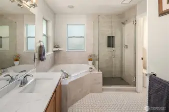 Primary bath was remodeled in 2023 with quartz counters, under mount double sinks, and tile flooring. The shower has custom frameless doors and a tile floor. Large garden tub from the '90s intact!