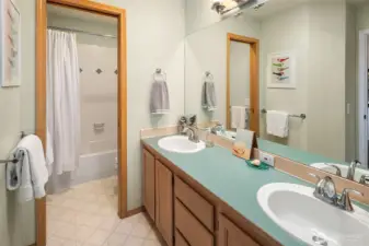 Double sinks, loads of storage and shower and toilet behind a separate door make this an ideal bathroom for sharing between the two rooms. Skylight gives you natural light over the sinks!