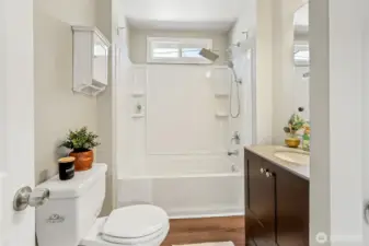 Light & bright bathroom with linen closet.