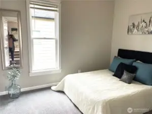 Designed as a restful escape, this primary bedroom retreat shows just how spacious it really is—with a QUEEN bed, nightstand, and plenty of breathing room.