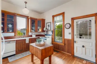 Spacious Craftsman Kitchen leads to charming back porch.