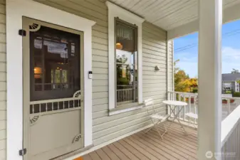 Covered Back Porch leads to yard and garage.