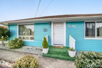 Welcoming front entry with covered porch, modern door, and low-maintenance landscaping in quiet residential neighborhood.