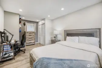 Secondary bedroom with modern flooring and closet storage — perfect for guests or family.