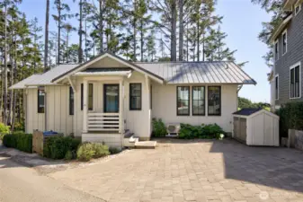 When you enter the home you are greeted with custom driveway pavers, a bike shed and a garbage enclosure to keep your outside clean and tidy.
