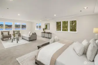 The primary suite is huge, with jaw droppingly gorgeous lake views. With a king sized bed, and a large sitting area, there's still oodles of room. Not shown is two enormous primary closets, and ensuite bathroom.