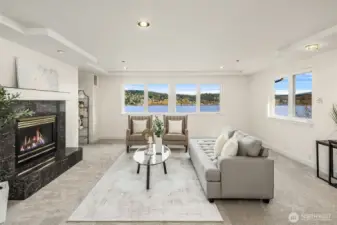 The sitting area in the main primary suite with a fireplace for comfort and ambiance. This room is plenty big enough to divide into two rooms to give three bedrooms upstairs. Or keep as is for a the most incredible private suite.