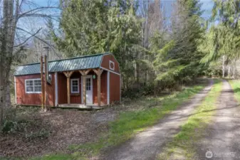 Outbuilding on the property has a wood stove.