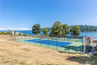 Pickleball, tennis and other athletic courts are available throughout North Bay. Community beach access is to the right of this court and downhill a grassy picnic area to the water.