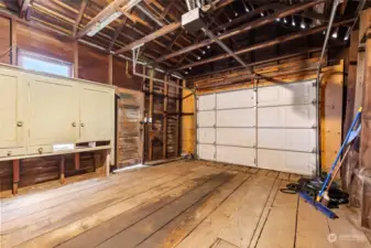 Garage has wide plank wood floors.