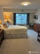 Primary bedroom has triple pane window for great sound reduction, comfy wall to wall carpet