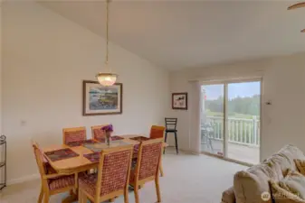 Dining room with sliding door to the north facing deck and ocean view.
