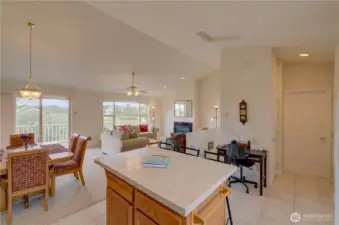 Kitchen with breakfast bar, dining room and living room.