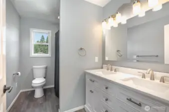 Upstairs full bath includes all new fixtures, quartz countertops & tile shower surround