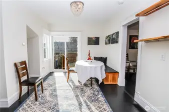 Dining room has built in benches with storage. Sliding door provides separate entry from side yard.