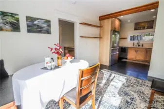 View from dining room into kitchen with main floor bedroom in view.