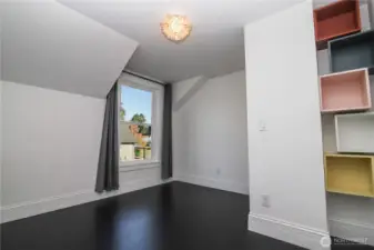 North facing bedroom with built-in storage cubbies.