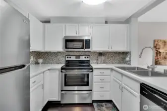 Bright white cabinets are highlighted by stainless steel appliances.