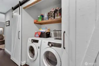 Washer and dryer discretely enclosed behind sliding barn doors, a nice design touch!