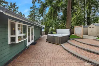 Patio extends length of the house. Hot tub conveys with home.