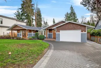 Driveway has been hand laid with pavers and custom lighting (a $30,000 investment)