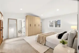 Spacious primary suite features built in wardrobe and walk in closet