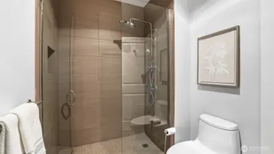Primary suite attached bath with frameless walk-in shower