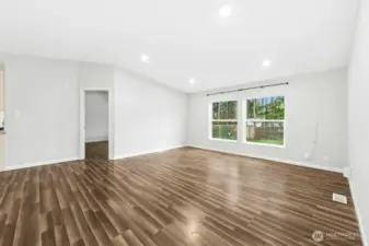 Living room and door to large primary bedroom.