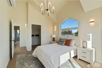 Primary bedroom with walk in closet on the upper level