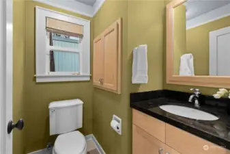 Powder room near the kitchen and backyard. Full medicine cabinet and pull out drawers in the wall cabinet.