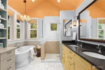 Ensuite primary bath features built in cabinets, heated Carrara marble floors, pedestal tub, walk in shower and dual sinks.