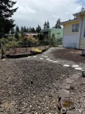 Walking path in front yard with another sitting area to the left