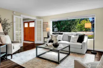 The Living Area is just off of the entry vestibule. With tons of natural light and glassy French doors..