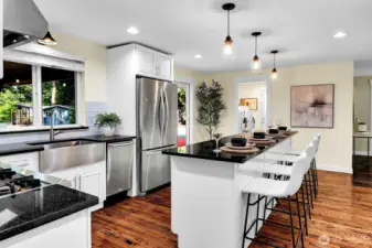 The countertop on the fabulously large island is granite. And just look at the size of that stainless sink!
